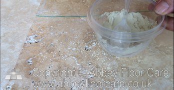 Sanded grout being mixed for filling small holes in travertine